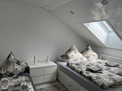 a attic bedroom with a bed and a window at Schwarzwald Appartement Steffanie in Freudenstadt