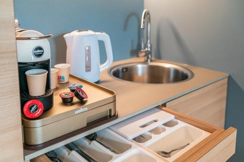 a kitchen with a sink and a counter top at Princess Aparthotel in Bibione