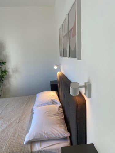 a bedroom with a bed with a pillow on it at Lovely Sea View 3 Bedroom Apt in Marsalforn Gozo. in Żebbuġ