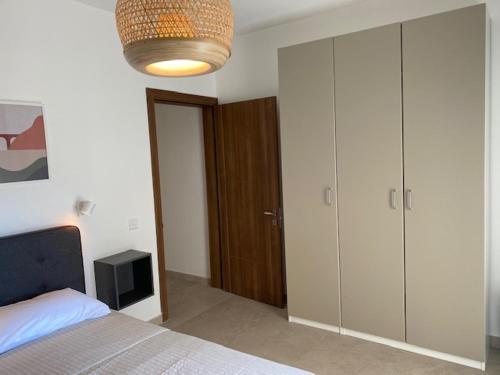 a bedroom with a bed and a large closet at Lovely Sea View 3 Bedroom Apt in Marsalforn Gozo. in Żebbuġ