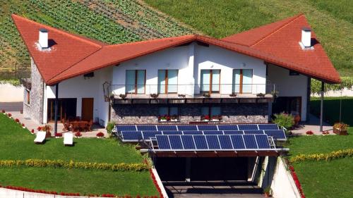 a house with solar panels on the front of it at Belabieta - baskeyrentals in Berrobi