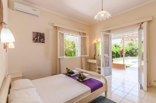 a small bedroom with a bed and a kitchen at Villa Stafili by Villa Plus in Litherés