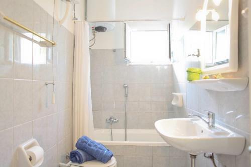 a bathroom with a sink and a toilet and a shower at Villa Stafili by Villa Plus in Litherés