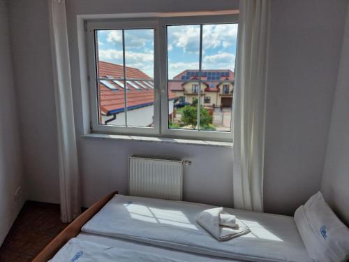a bed in a room with a large window at Apartamenty Hexagon nr16 in Grzybowo