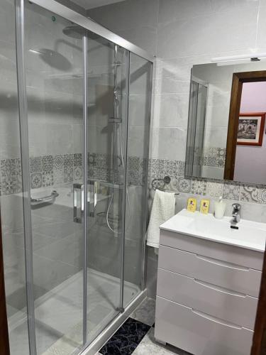 a bathroom with a shower and a sink at Hotel Plaza Damasco in Almuñécar