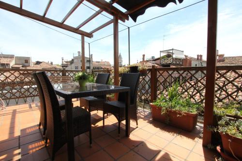 
a dining room table with chairs and a patio at City Apartments San Marco in Venice
