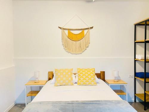 a bedroom with a bed and two tables with pillows at Altamar in Santa Teresa Beach