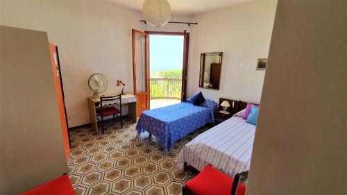 um quarto de hotel com duas camas e uma varanda em Appartamento spazioso e fresco in punto strategico. em Castellammare del Golfo