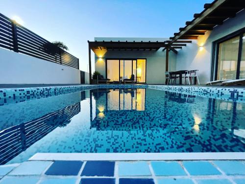 a swimming pool in the backyard of a house at Samoqueira 12 in Porto Covo