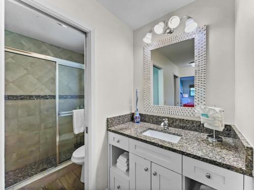 a bathroom with a sink and a mirror at Spacious Updated Condo Just 2 Blocks to Siesta Key Beach in Siesta Key