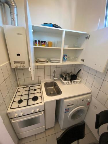 a small kitchen with a stove and a sink at Hubert in Berlin