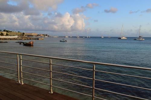 a view of a body of water with boats at Tradewinds Apartments Simpson Bay in Simpson Bay