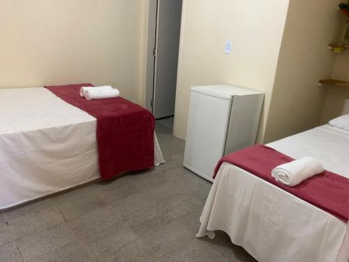 A bed or beds in a room at POUSADA DO SOL ITAUNAS