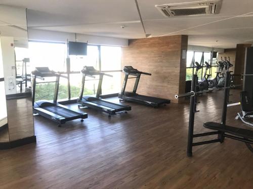 a gym with several tread machines in a room at FLAT BEIRA MAR BARRA DE JANGADA ANDAR ALTO JABOATão in Recife