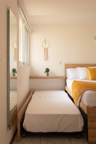 a bedroom with two beds and a mirror at Silver Sun Apartment in Guatemala