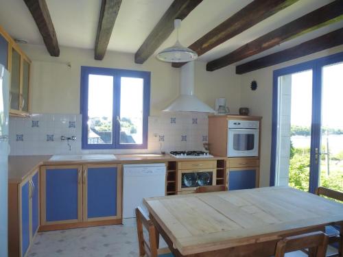 a kitchen with a wooden table and a dining room at Holiday Home near Goëlo Coast & Beaches in Plourivo