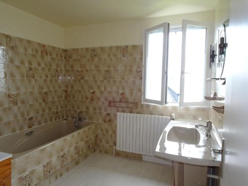 a bathroom with a bath tub and a sink at Holiday Home near Goëlo Coast & Beaches in Plourivo