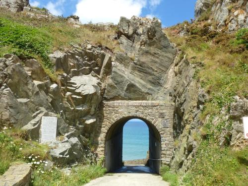 an archway in a mountain with the ocean through it at Holiday Home near Goëlo Coast & Beaches in Plourivo