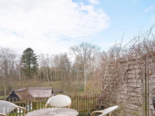 a patio with chairs and a fence and a yard at 2 person holiday home in Aakirkeby-By Traum in Vester Sømarken