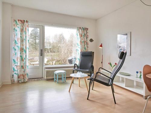 a living room with two chairs and a window at 2 person holiday home in Aakirkeby-By Traum in Vester Sømarken