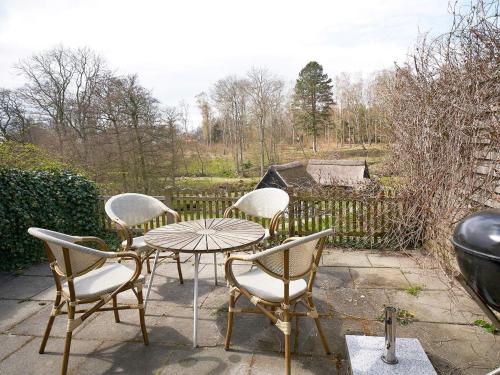 a patio with a table and chairs and a fence at 2 person holiday home in Aakirkeby-By Traum in Vester Sømarken