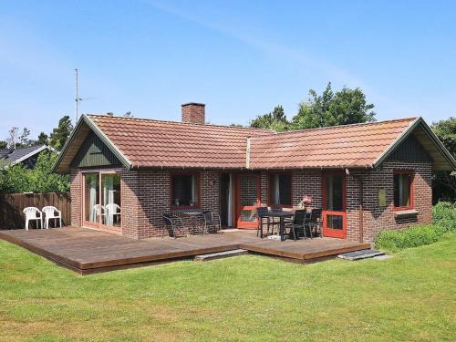 a small brick house with a wooden deck at Secluded Retreat in Blavand - By Traum Ferienwohnungen in Blåvand
