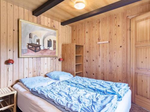 a bedroom with a bed in a wooden wall at Secluded Retreat in Blavand - By Traum Ferienwohnungen in Blåvand