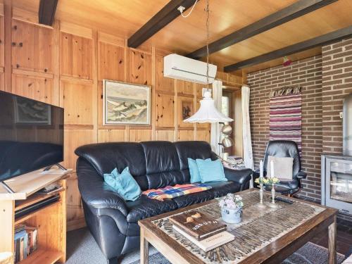 a living room with a leather couch and a table at Secluded Retreat in Blavand - By Traum Ferienwohnungen in Blåvand