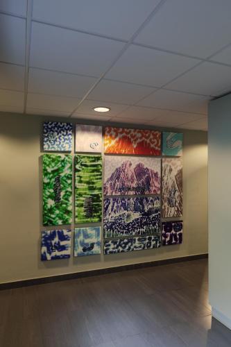 a room with paintings of mountains on the wall at Roca Blanca in Espot