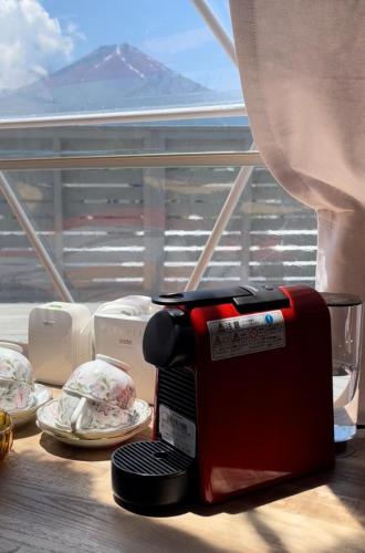 a coffee maker sitting on a table in front of a window at Necoana Glamping in Fujikawaguchiko