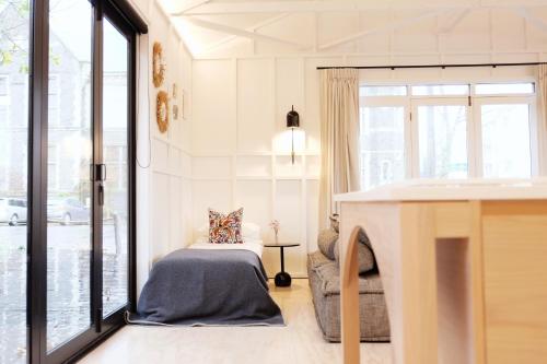 - un salon avec un lit et une cheminée dans l'établissement The Tack Rooms, à Christchurch