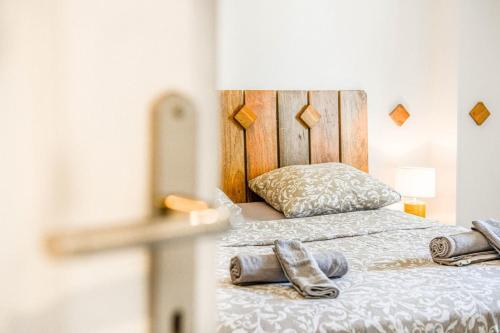 a bedroom with a bed with shoes on it at Le Fortia - Vieux-Port 2 chambres avec balcon in Marseille