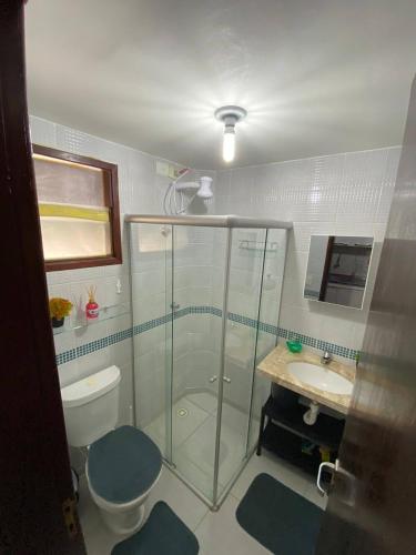 a bathroom with a shower and a toilet and a sink at Winterville residence in Gravatá
