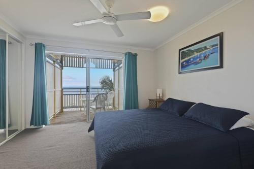 a bedroom with a bed and a view of the ocean at Villa 52 Tangalooma in Tangalooma