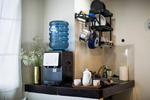 a kitchen counter with a coffee maker on top of it at Sanmaru- Serpong Garden apt 2 Br become 1 bigroom in Tangerang