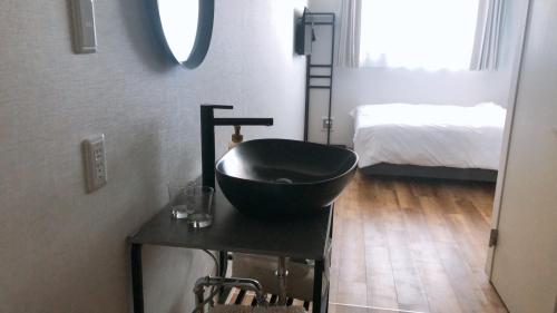 a bathroom with a black bowl sink on a table at Megu Fuji 2021 in Fujiyoshida