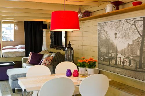 a living room with a table and chairs at Houseboat Prince-Avalon in Amsterdam