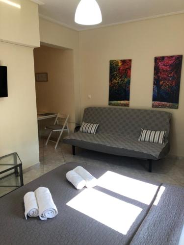 a living room with a couch and a bed at Chris 2 in Kalamata