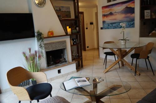 a living room with a table and a fireplace at Window on the mountains in Breuil-Cervinia