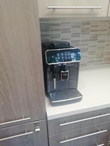 a black coffee maker sitting on top of a kitchen counter at Tomsona Apartment Riga Center in Rīga