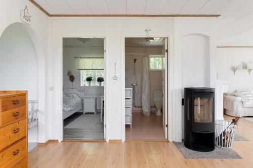 a white room with a bedroom and a bed at Nice cottage in Sjuhult with proximity to Lake Rymmen in Rydaholm