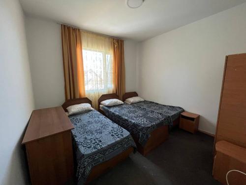 Postel nebo postele na pokoji v ubytování Гостевой дом Акварель 阿克瓦雷爾旅館 Guest house Akvarel 게스트하우스 아크바렐