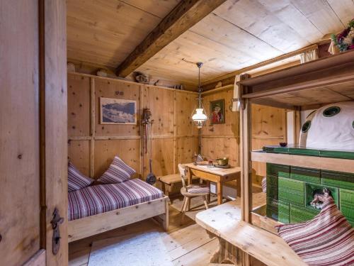 a room with a couch and a table in a cabin at Garni Anni in Gerlos