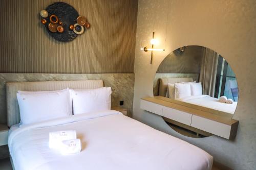 a hotel room with two beds and a mirror at STAY BY LATINEM Luxury 1BR Holiday Home CV A2605 near to Burj Khalifa in Dubai