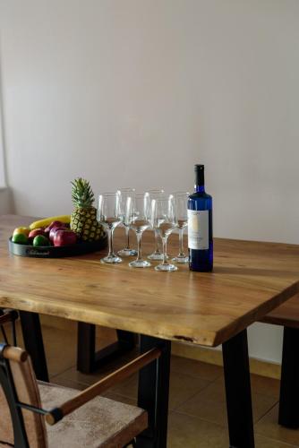 a table with wine glasses and a plate of fruit at Diva Santorini Luxury Villa in Pirgos