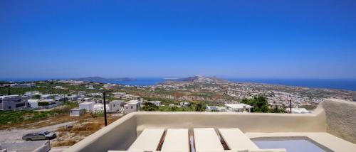 a view of the city from the balcony of a house at Diva Santorini Luxury Villa in Pyrgos