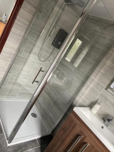 a bathroom with a shower and a sink at Meadowview Cottage, St Ives View in Camborne