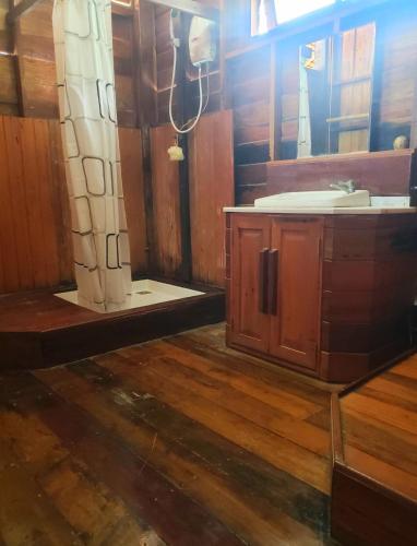 a bathroom with a shower and a sink and a mirror at Lipe BeachHouse in Ko Lipe