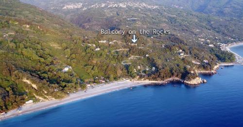 an aerial view of a beach with a sign baby on the rocks at Balcony on the Rocks in Agii Saranta