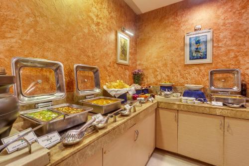 a buffet line with many trays of food at Golden Tulip New Delhi - Hari Nagar in New Delhi